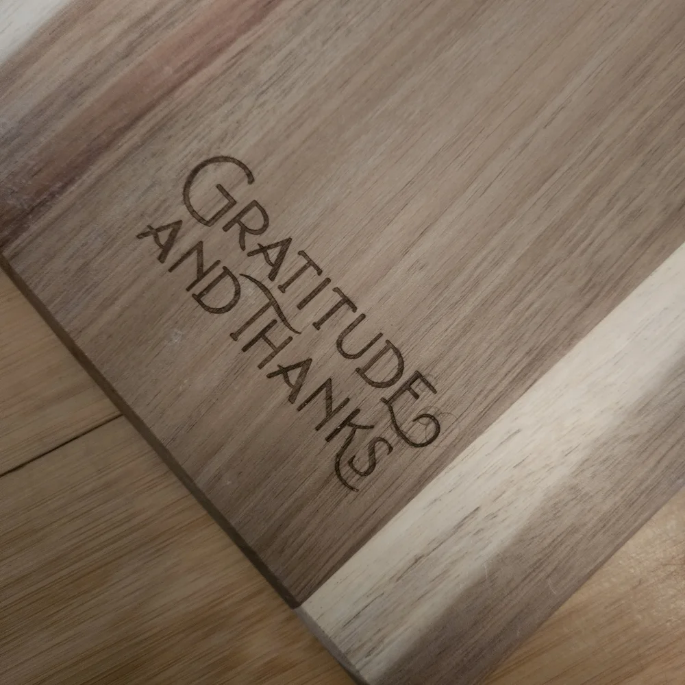 TOSCANA serving plank engraving says gratitude and Thanks.